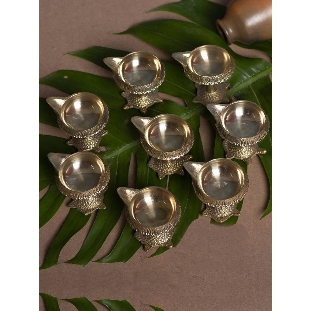Tied Ribbons Gold Toned 8 Pieces Decorative Brass Diyas With Tortoise Base | Grocsy