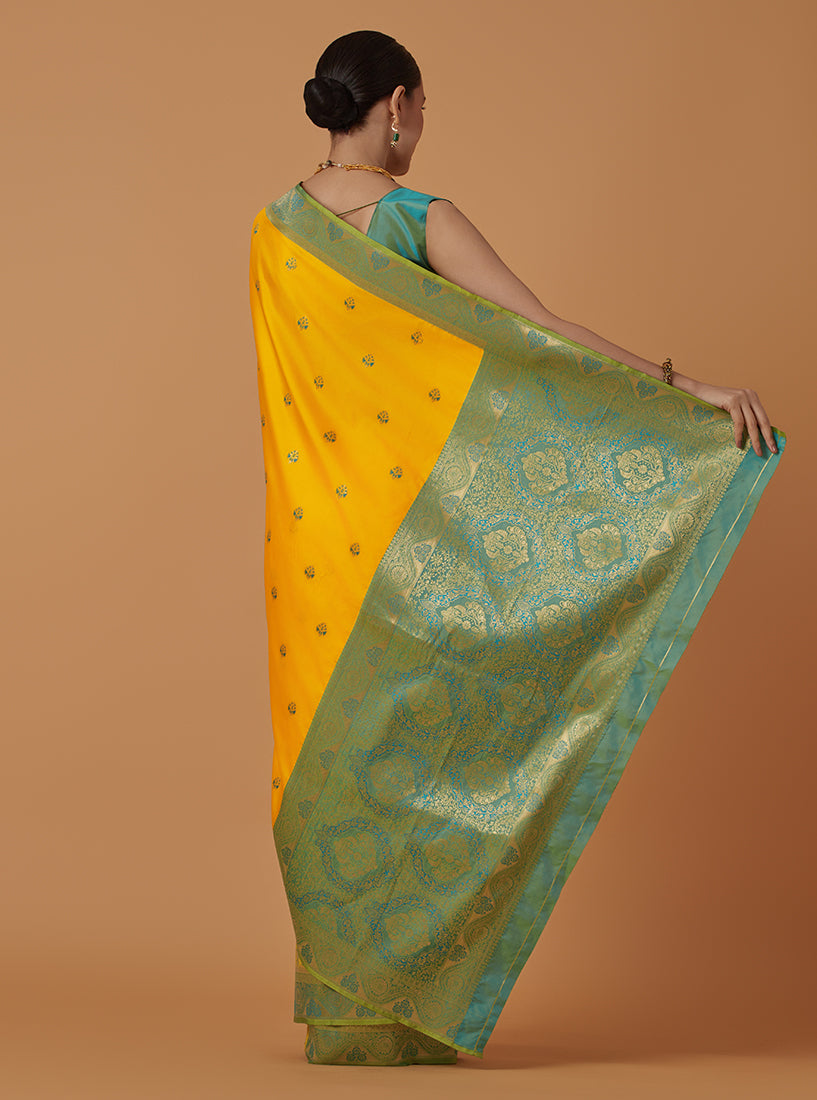 Monjolika Fashion Yellow Banarasi Silk Blend SareeWith Traditional & Modern Dulha Dulhan Figure Zari Woven Detailing | Grocsy