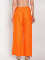 TAG 7 Women Orange Solid Flared Palazzos | Grocsy