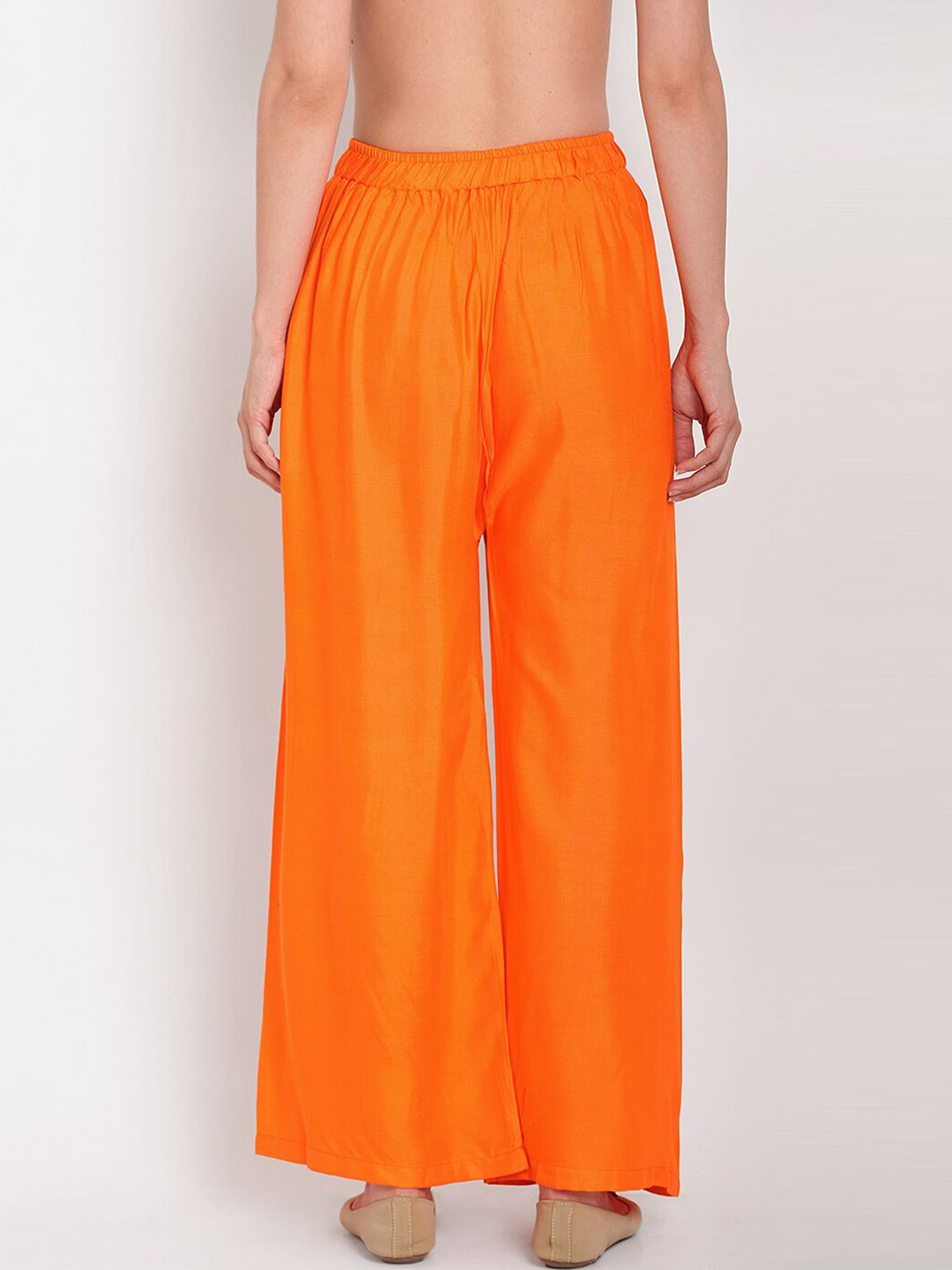TAG 7 Women Orange Solid Flared Palazzos | Grocsy