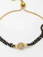 NVR Women Gold-Polished & Black Brass AD-Studded Hand Mangalsutra Bracelet | Grocsy
