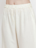 TAG 7 Women Off-White Solid Flared Palazzos | Grocsy