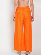 TAG 7 Women Orange Solid Flared Palazzos | Grocsy
