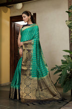 Vardha Teal Green Golden Zari Banarasi Raw Silk Saree | Grocsy