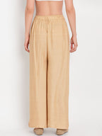 TAG 7 Women Beige Solid Flared Palazzos | Grocsy