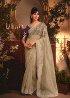 Monjolika Fashion Designer Beige Tissue Organza Saree With All Over Butta Work & Heavy Stone Embellished Border | Grocsy