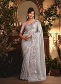 Monjolika Fashion Designer Light Grey Tissue Organza Saree With All Over Butta Work & Heavy Stone Embellished Border | Grocsy