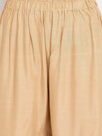 TAG 7 Women Beige Solid Flared Palazzos | Grocsy