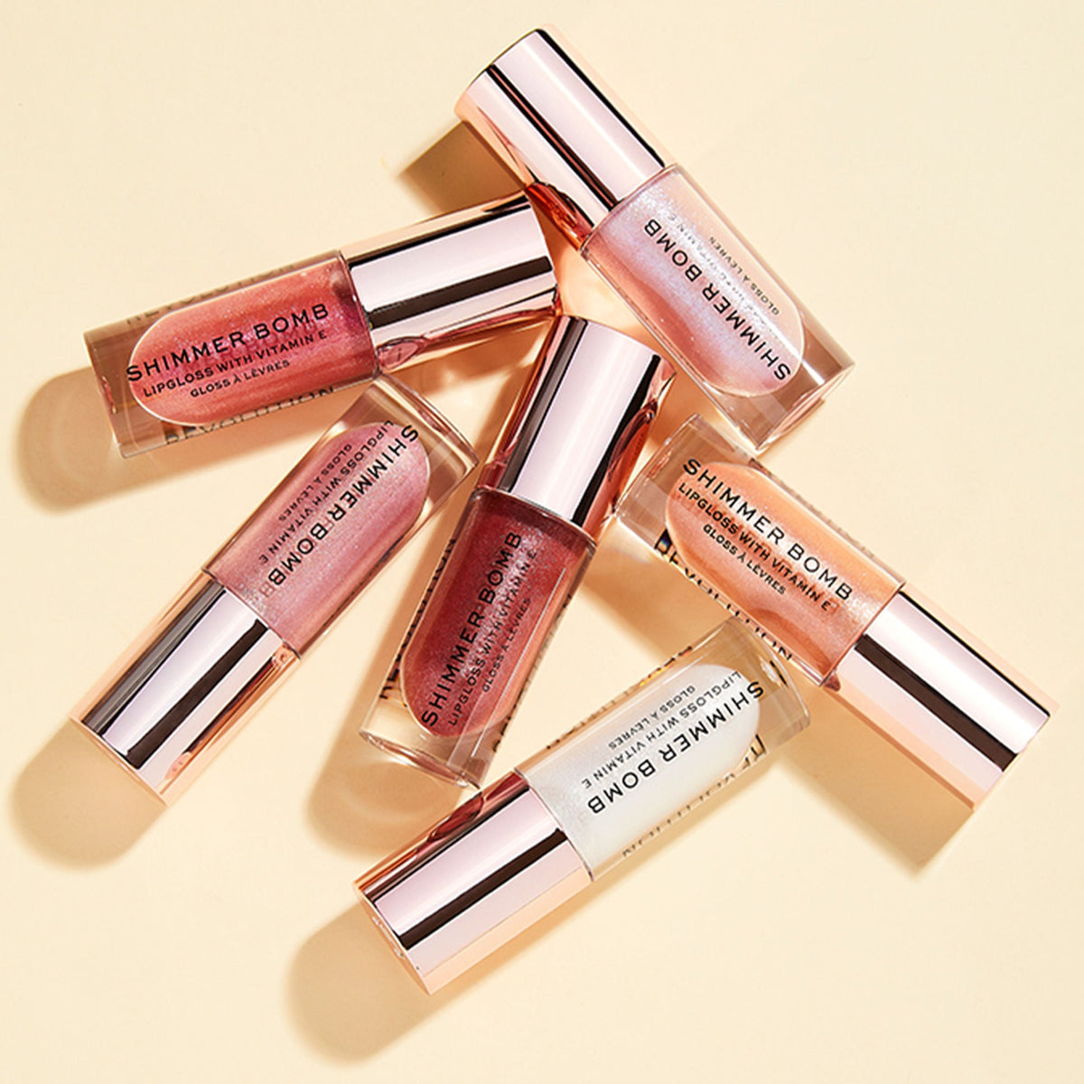 Makeup Revolution Shimmer Bomb Lip Gloss Infused With Vitamin E For Extra Nourishment - Glimmer Nude | Grocsy