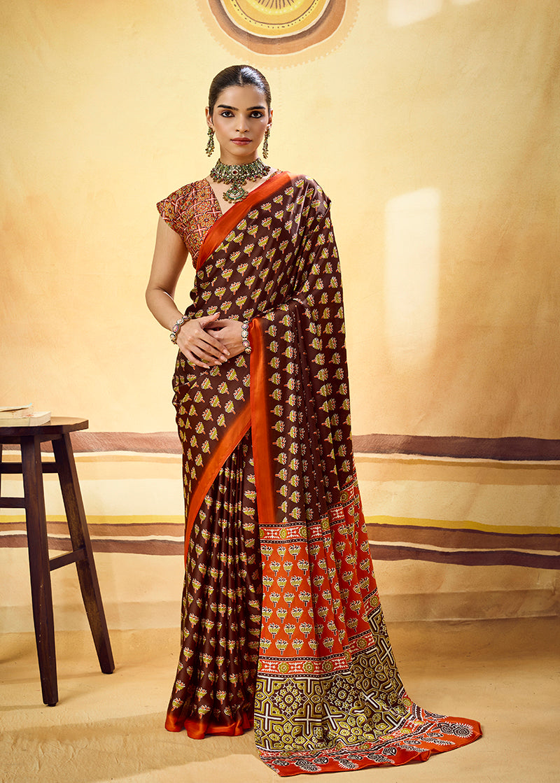Monjolika Fashion Brown Satin Printed Saree With Orange Border And Unstiched Blouse | Grocsy