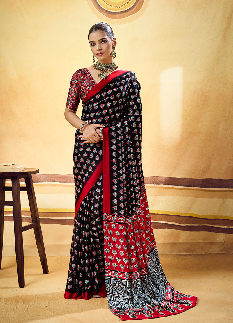 Monjolika Fashion Black Satin Printed Saree With Orange Border And Unstiched Blouse | Grocsy