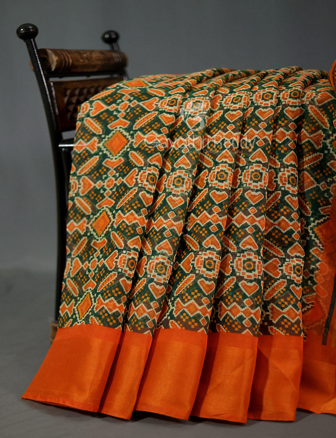 Shades of Dark Green And Orange Colour Patola Print Semi Chanderi Saree By Gayathri Reddy Designer Studio | Grocsy