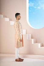 The Peach Sherwani Features Hexagonal Butas , V-Shaped Floral Jal Borders by Hilo Design | Grocsy