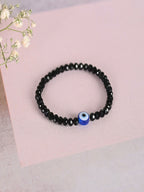 NVR Women & Men Black Evil Eye Elasticated Rakhi With Roli Chawal | Grocsy