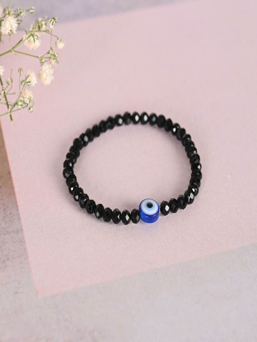 NVR Women & Men Black Evil Eye Elasticated Rakhi With Roli Chawal | Grocsy