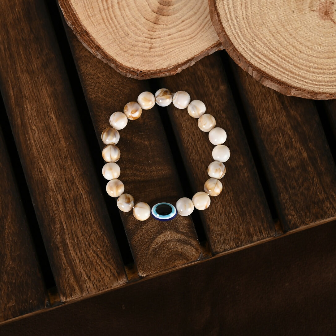 NVR Women & Men Cream-colored Evil Eye Elasticated Rakhi With Roli Chawal | Grocsy
