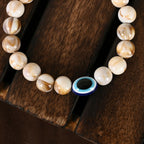 NVR Women & Men Cream-colored Evil Eye Elasticated Rakhi With Roli Chawal | Grocsy