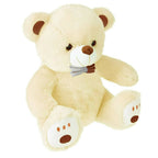 Webby Plush Cute Sitting Teddy Bear Soft Toys with Neck Bow and Foot Print (Beige) | Grocsy