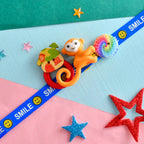trueBrowns X Voylla Colourful Monkey And Pinwheel Kids Rakhi For Kids | Grocsy