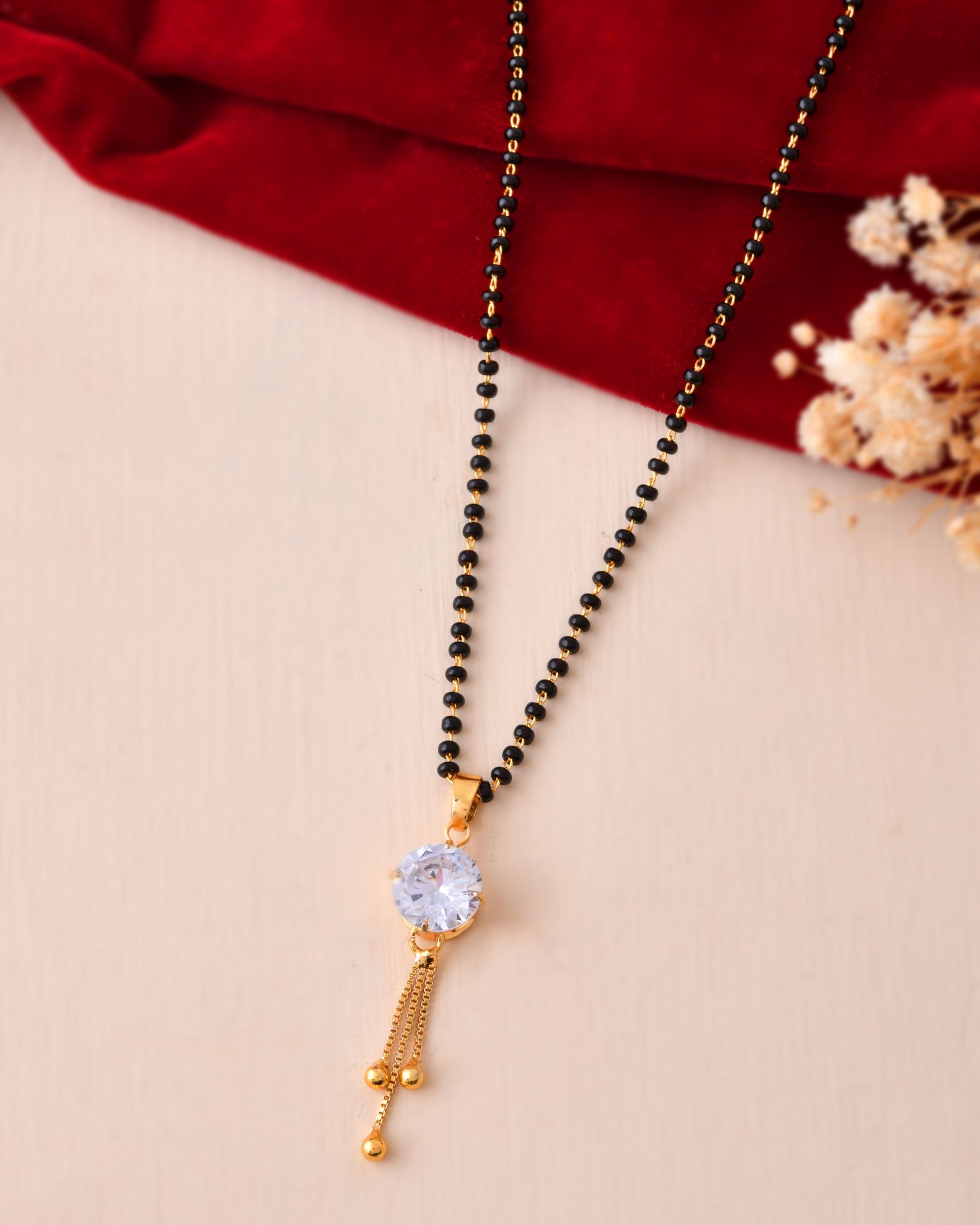 Jewels Nest Classic Gold-Tone White Stone Mangalsutra With Single Drop Tassel Pendant | Grocsy