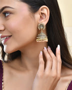 Jewels Nest Antique Gold-Polished Jhumka Earrings with Floral Detailing and Stone Embellishments
