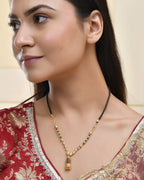 Jewels Nest Graceful Gold-Polished Black Bead Mangal Sutra with Intricate Pendant | Grocsy