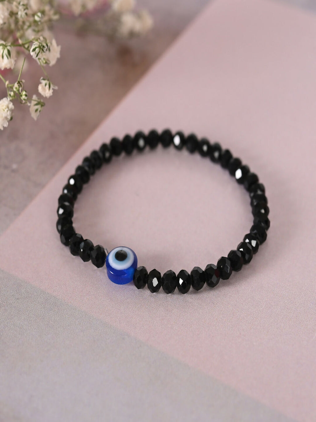 NVR Women & Men Black Evil Eye Elasticated Rakhi With Roli Chawal | Grocsy