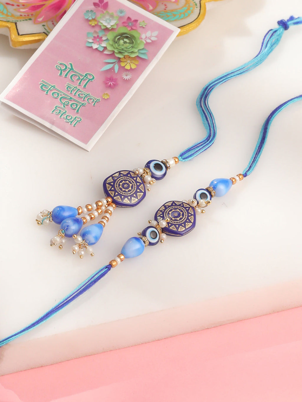 NVR Evil Eye Set of 2 Blue Artificial Beads Bhaiya Bhabhi Rakhi with Roli Chawal Chandan & Mishri | Grocsy
