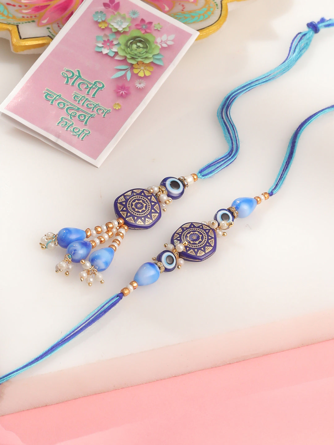 NVR Evil Eye Set of 2 Blue Artificial Beads Bhaiya Bhabhi Rakhi with Roli Chawal Chandan & Mishri | Grocsy