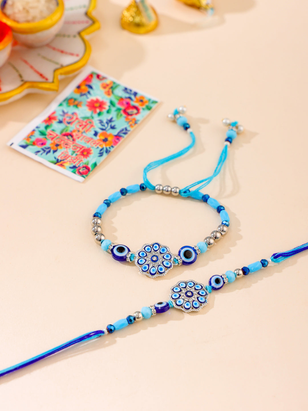 NVR Set of 2 Blue Evil Eye Floral Design Bhaiya Bhabhi Rakhi with Roli Chawal Chandan & Mishri | Grocsy