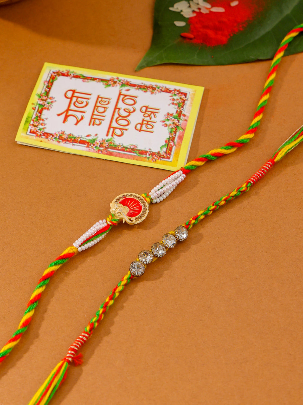 NVR Men Set of 2 Religious Designer Multicolor Artificial Stones Thread Rakhi with Roli Chawal Chandan & Mishri | Grocsy