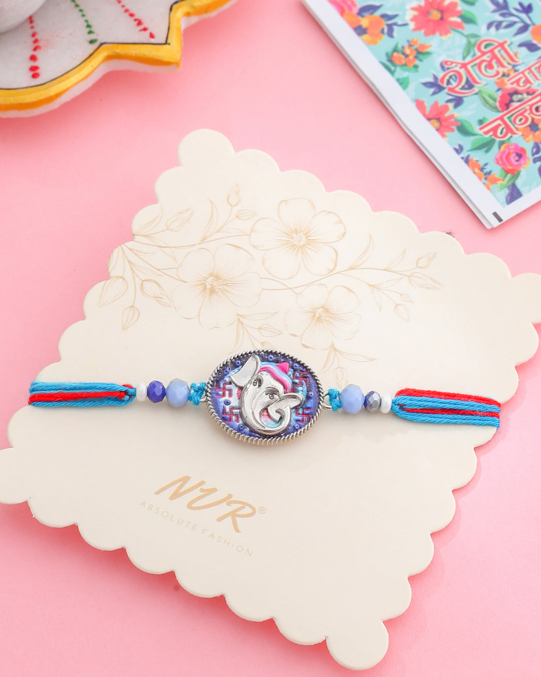 NVR Men Red & Blue Ganesh Ji Thread Rakhi with Roli Chawal Chandan & Mishri | Grocsy