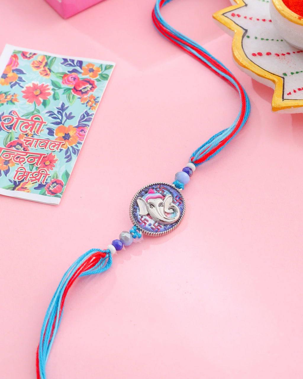 NVR Men Red & Blue Ganesh Ji Thread Rakhi with Roli Chawal Chandan & Mishri | Grocsy