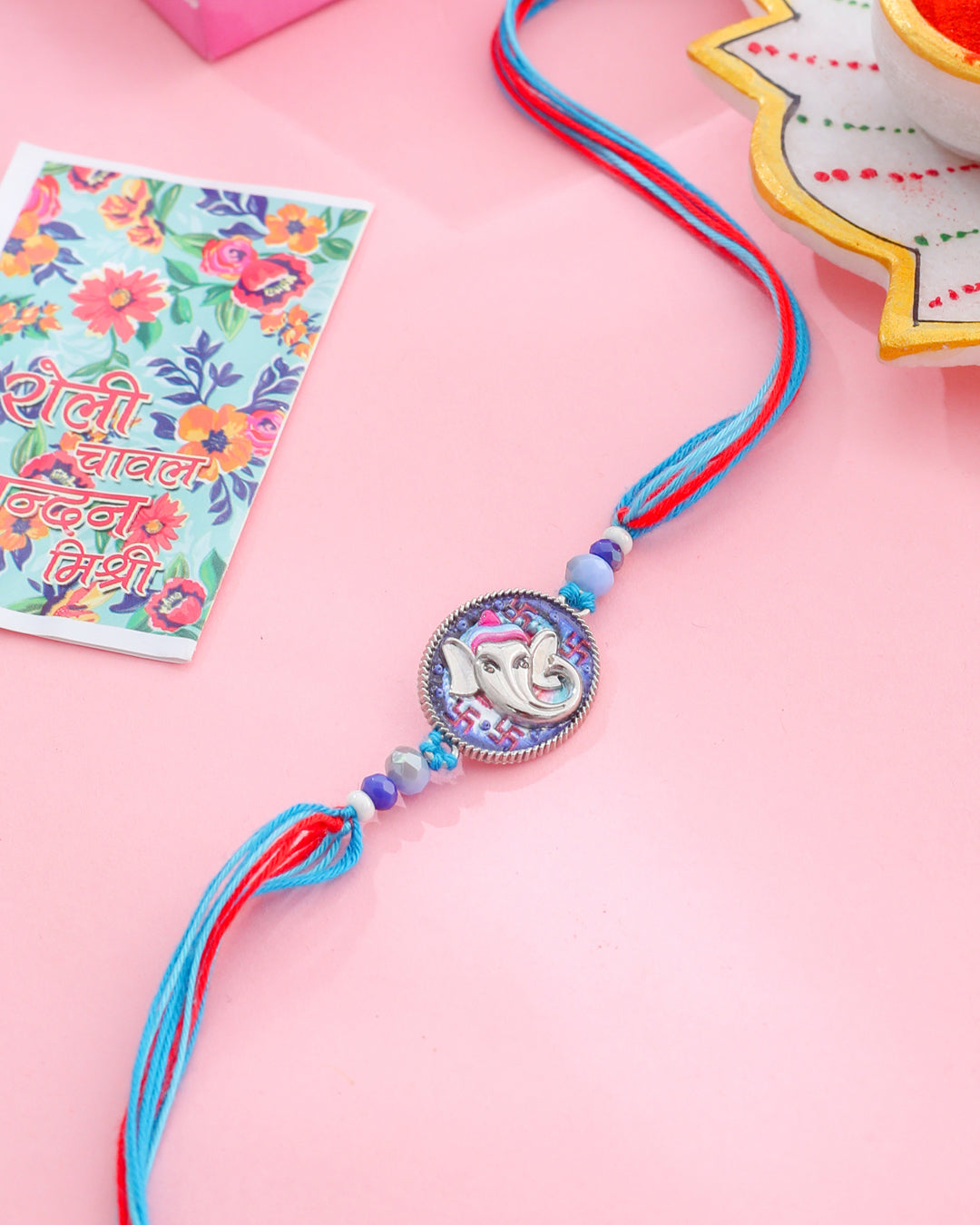 NVR Men Red & Blue Ganesh Ji Thread Rakhi with Roli Chawal Chandan & Mishri | Grocsy