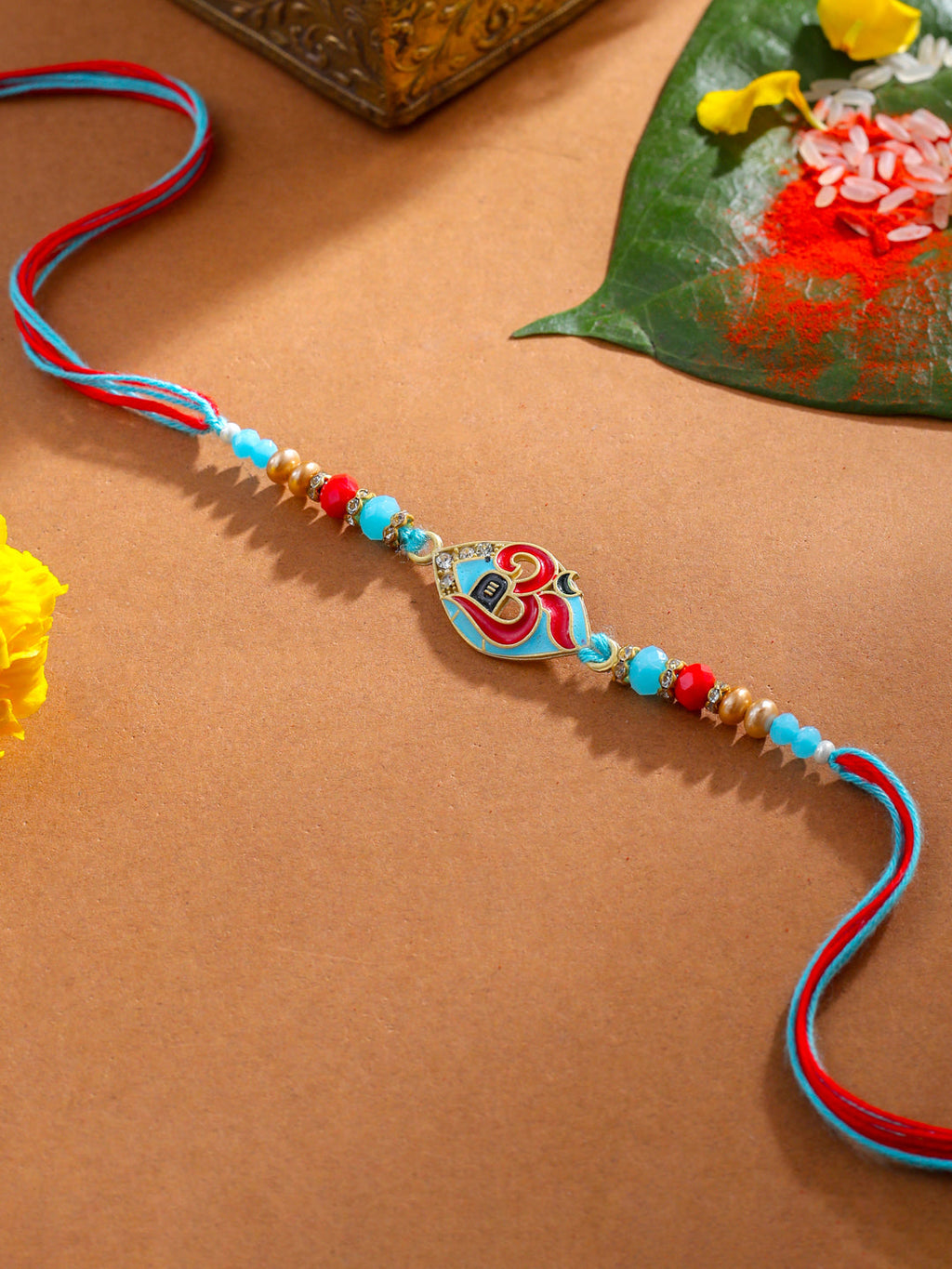NVR Men Red & Blue Artificial Stones and Beads Om Thread Rakhi with Roli Chawal Chandan & Mishri | Grocsy