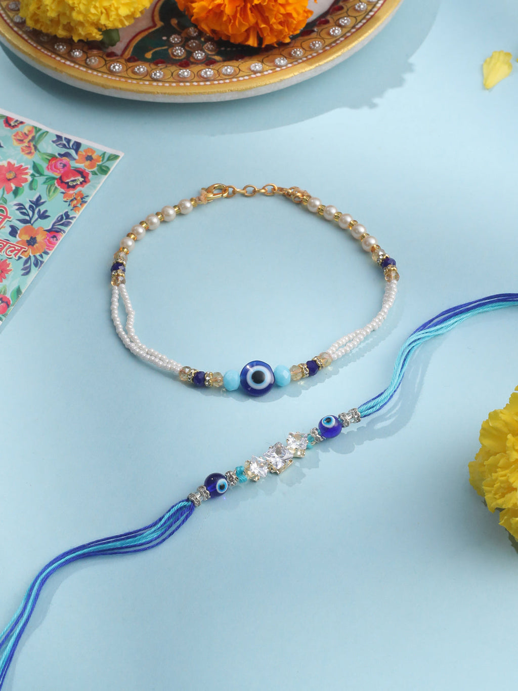 NVR Set of 2 Blue Evil Eye Artificial Stones & Beads Bhaiya Bhabhi Rakhi with Roli Chawal Chandan & Mishri | Grocsy