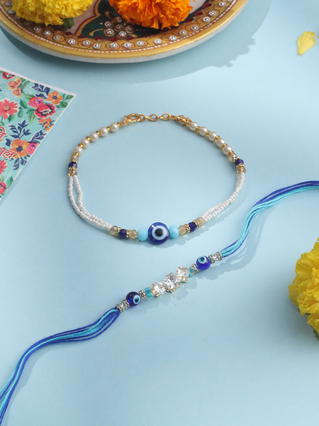 NVR Set of 2 Blue Evil Eye Artificial Stones & Beads Bhaiya Bhabhi Rakhi with Roli Chawal Chandan & Mishri | Grocsy