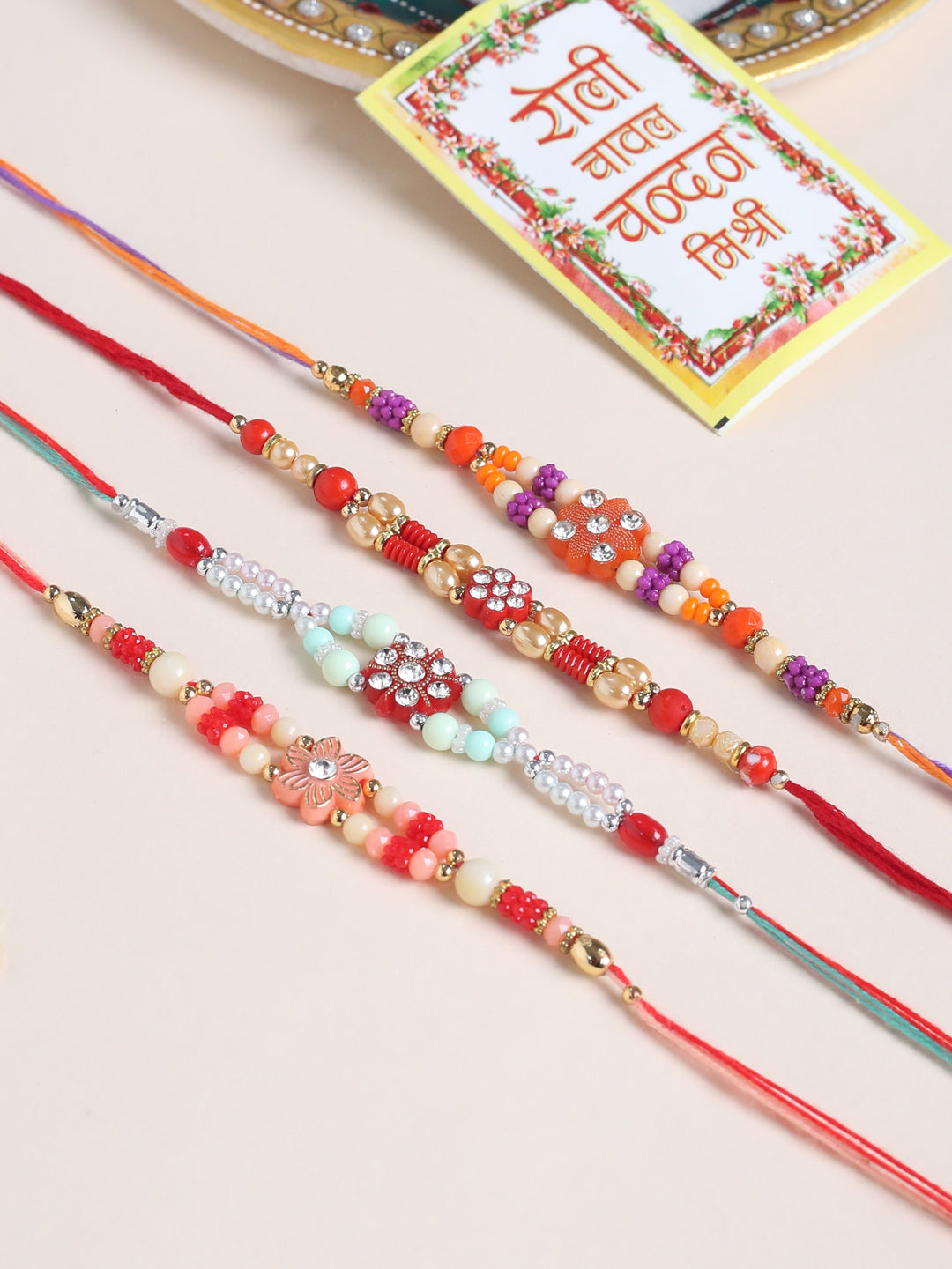 NVR Men Set of 4 Floral Design Multicolor Artificial Stones and Beads Thread Rakhi with Roli Chawal Chandan & Mishri | Grocsy