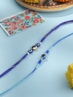NVR Men Set of 2 Blue Evil Eye Artificial Beads Thread Rakhi with Roli Chawal Chandan & Mishri | Grocsy