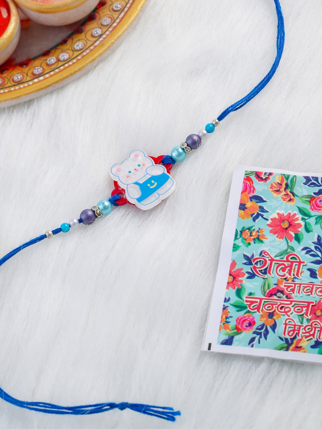 NVR Kids Teddy Blue Artificial Beads Thread Rakhi with Roli Chawal Chandan & Mishri | Grocsy