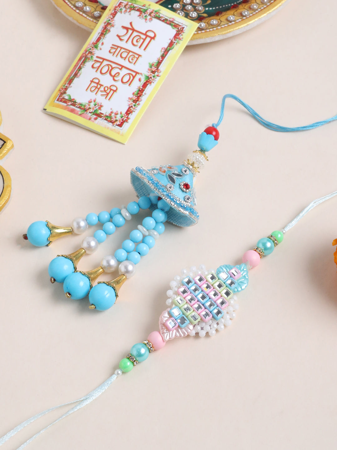 NVR Set of 2 Blue & Pink Artificial Stones & Beads Bhaiya Bhabhi Rakhi with Roli Chawal Chandan & Mishri | Grocsy