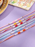 NVR Men Set of 6 Multicolor Pearls Thread Rakhi with Roli Chawal Chandan & Mishri | Grocsy