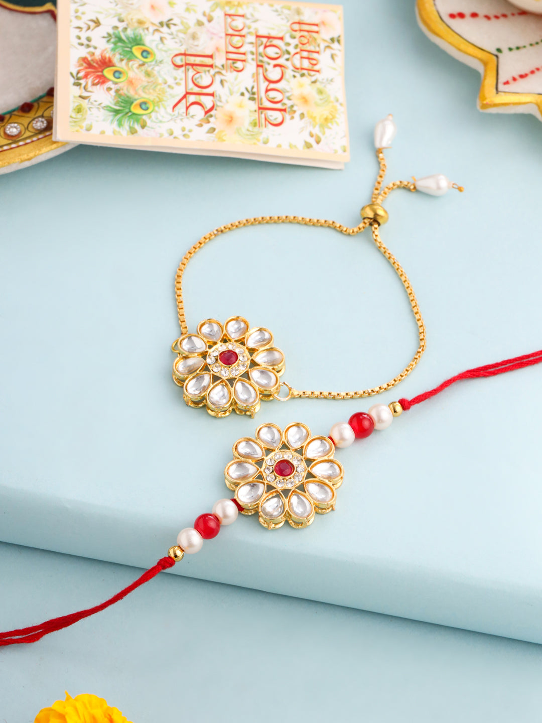 NVR Set of 2 Gold Toned Kundan Studded Floral Design Bhaiya Bhabhi Rakhi Set with Roli Chawal Chandan & Mishri | Grocsy