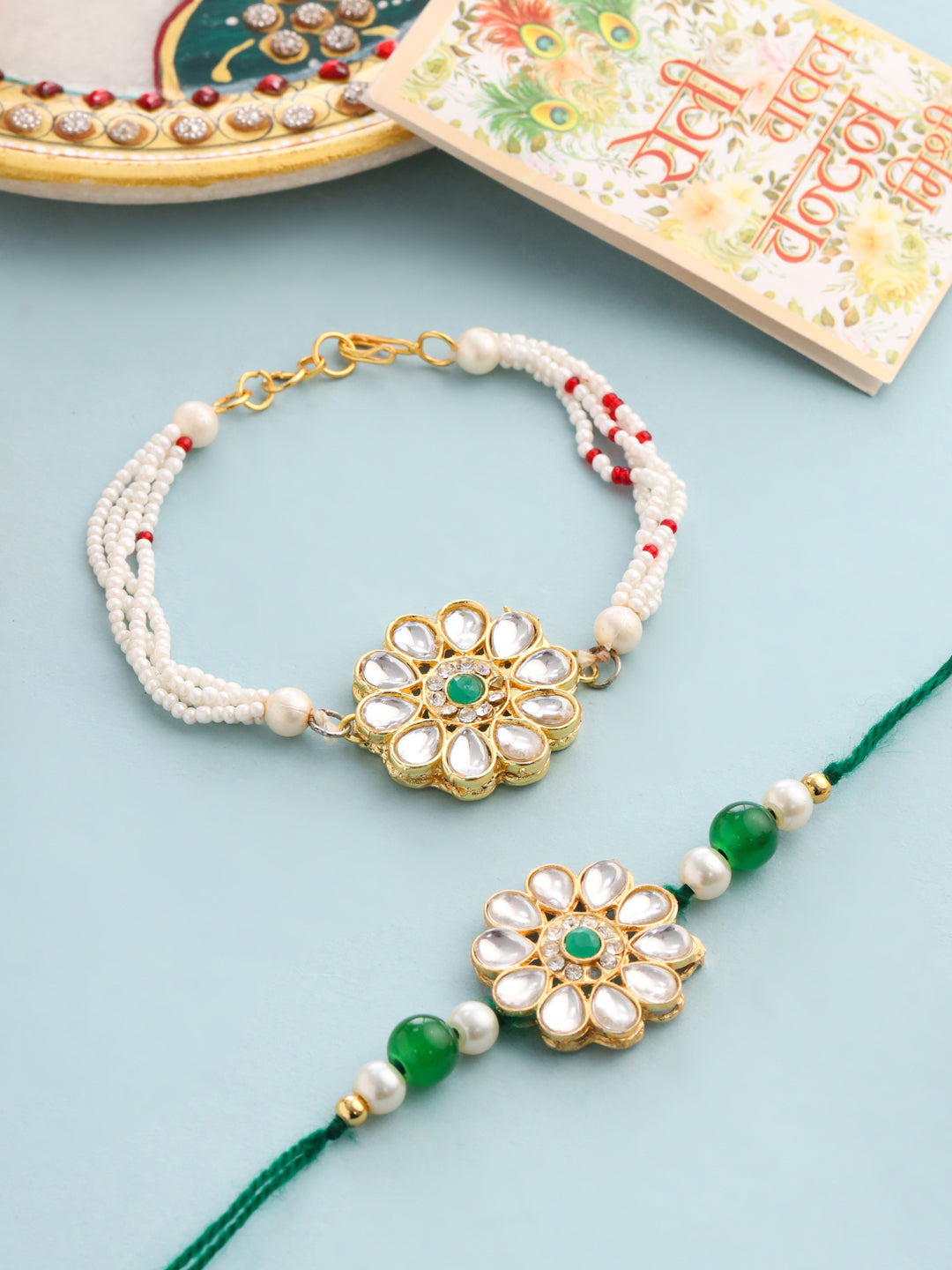 NVR Set of 2 Kundan Studded Floral Design Gold Toned Bhaiya Bhabhi Rakhi Set with Roli Chawal Chandan & Mishri | Grocsy