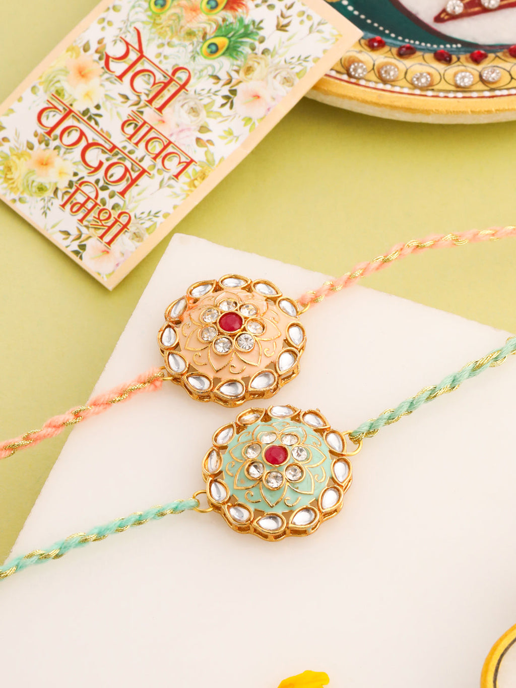 NVR Men Set of 2 Peach & Green Kundan Studded Round Floral Design Rakhi with Roli Chawal Chandan & Mishri | Grocsy