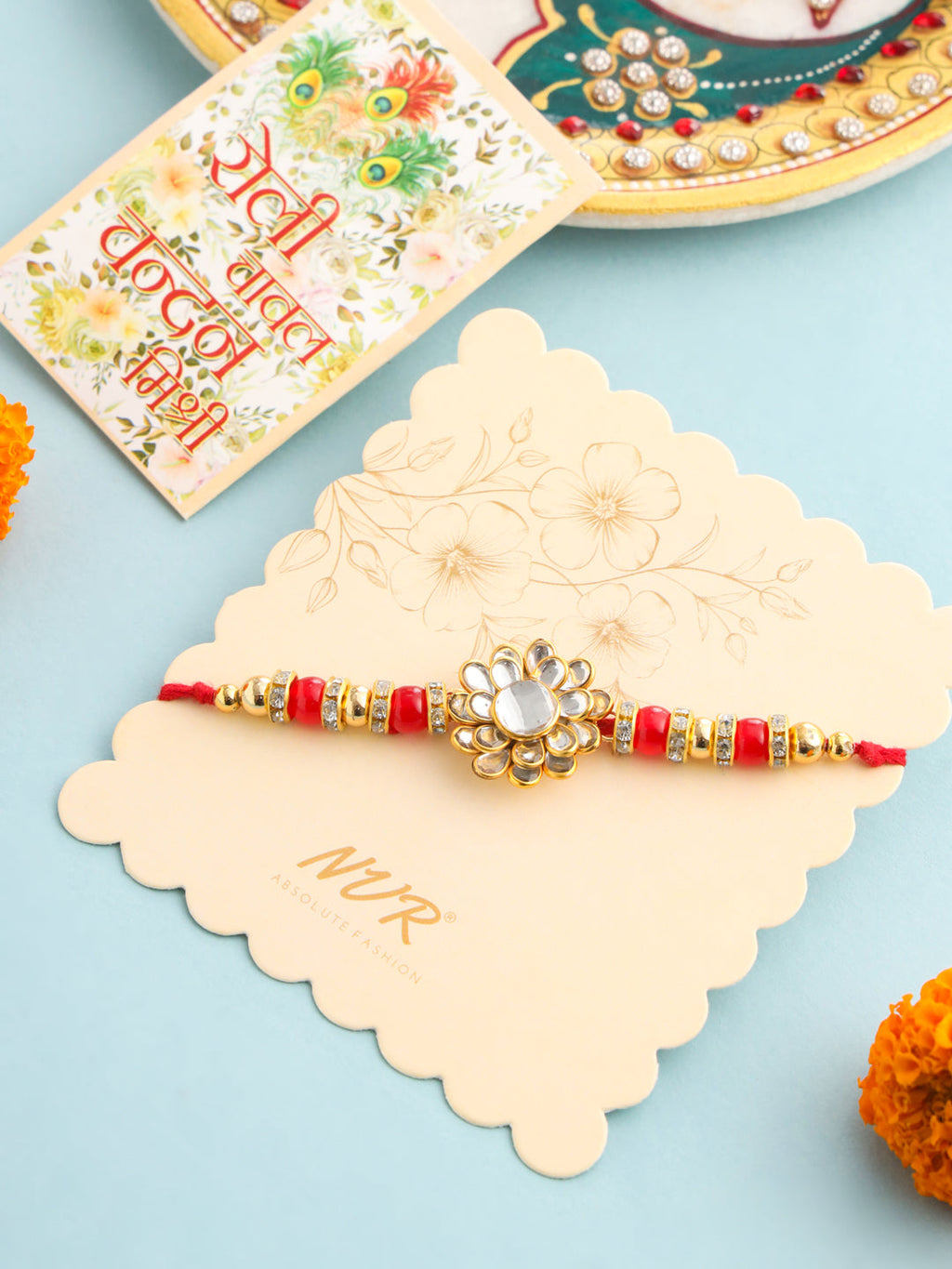 NVR Men Red Kundan Studded Floral Design Thread Rakhi with Roli Chawal Chandan & Mishri | Grocsy