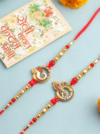 NVR Men Set of 2 Golden Red Religious Designer Ganesh Ji Thread Rakhi With Roli Chawal Chandan & Mishri | Grocsy
