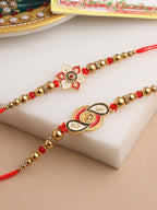NVR Men Set of 2 Red & Gold Floral Design Artificial Beads Thread Rakhi With Roli Chawal Chandan & Mishri | Grocsy