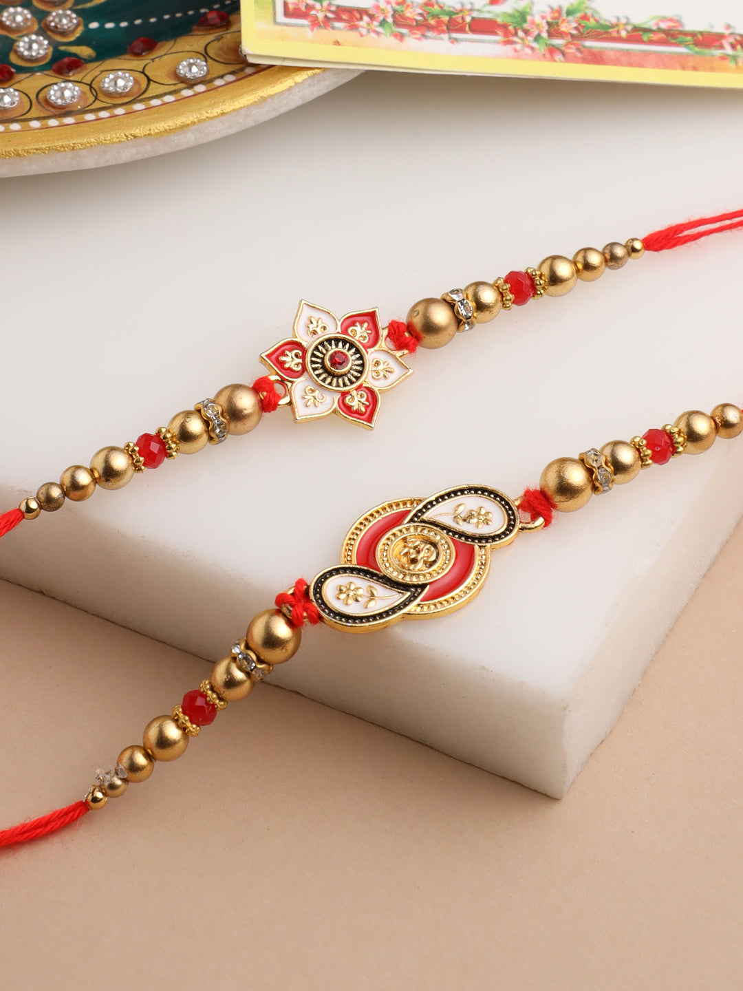 NVR Men Set of 2 Red & Gold Floral Design Artificial Beads Thread Rakhi With Roli Chawal Chandan & Mishri | Grocsy