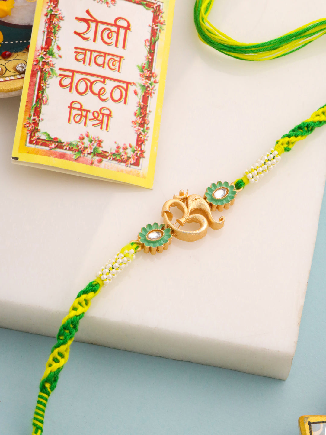 NVR Men Green Kundan Studded Om Design Thread Rakhi with Roli Chawal Chandan & Mishri | Grocsy